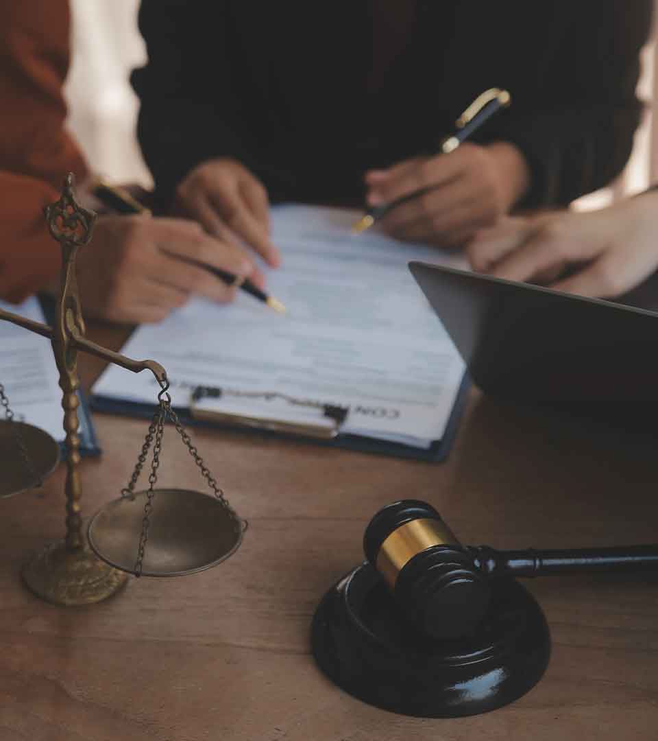 Charitable Trust Attorney Denver Gavel and scales beside people signing documents - Charitable Trust Attorney Denver