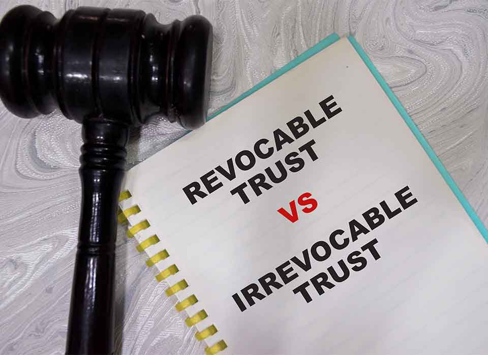 Revocable Living Trust Attorney Denver Gavel beside document titled Revocable vs Irrevocable Trust